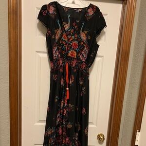 Black dress, sleeveless, high/low. Looks great on